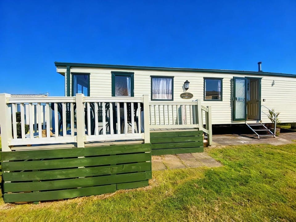 View of The Wee Sprout with Decking and pathway to the Caravan. Shows steps