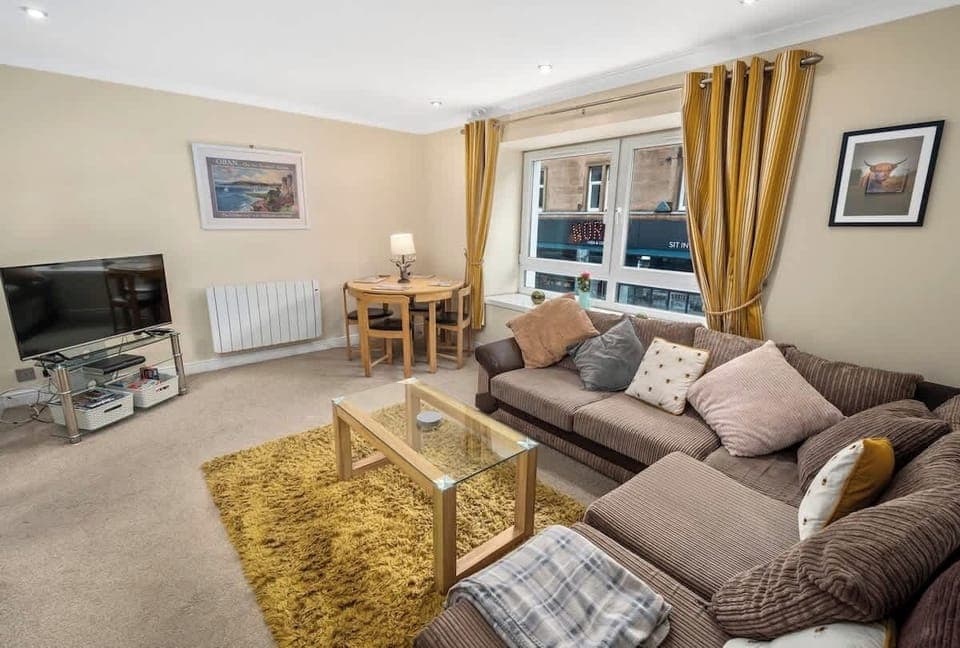 Living area with ample natural lighting and comfortable seating