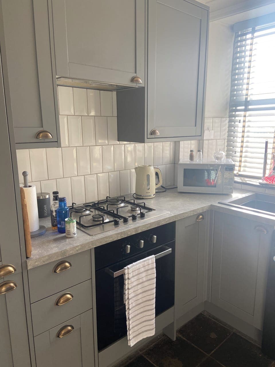 Modern kitchen, has air fryer, microwave and full cooker, toaster, kettle.