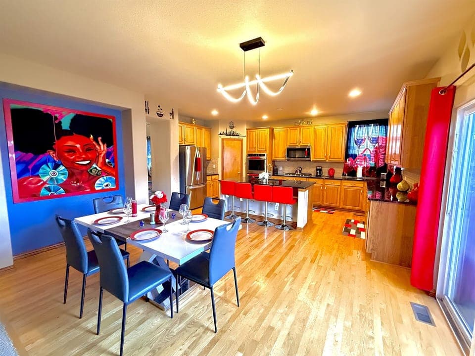 Vast kitchen and dining space overlooking a charming patio, offering a delightful atmosphere for dining and unwinding