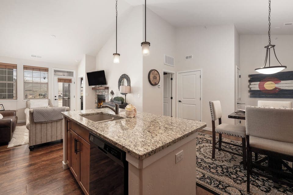 Your gourmet kitchen island beckons with granite counters and pendant lighting, flowing seamlessly into cozy living spaces perfect for gathering.