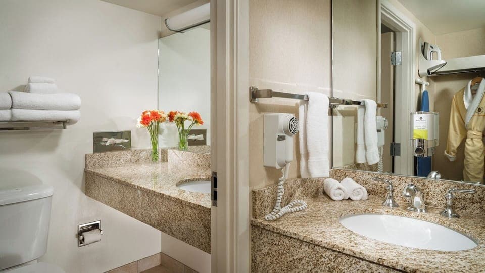 Refresh at a bright granite vanity with fluffy towels.