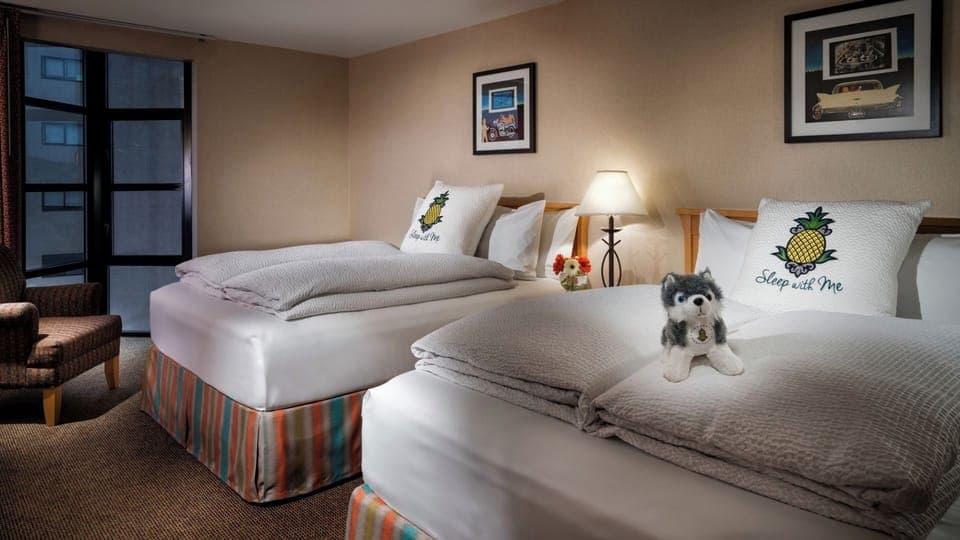 Unwind in cozy double beds with warm, restful lighting.