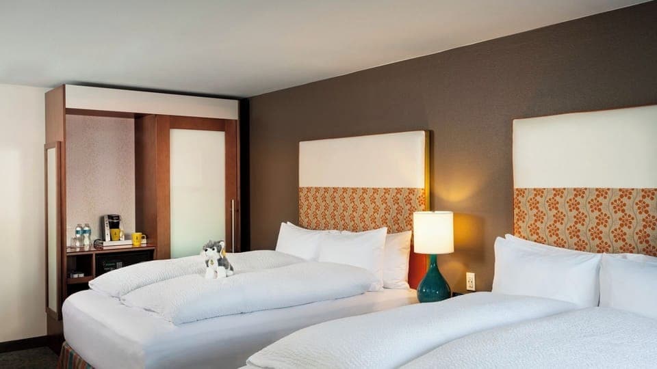 Drift off in crisp white linens beneath stylish headboards.