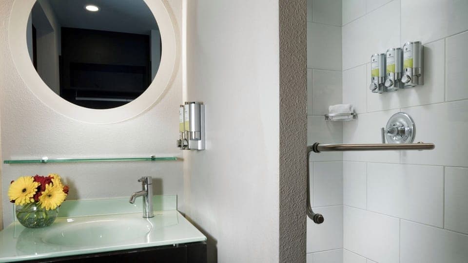Unwind with a bright vanity and easy step-in shower.