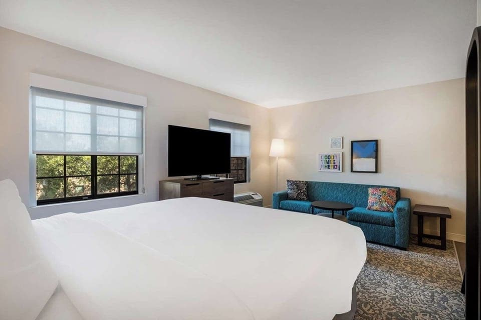 Lounge by the window with a show on the big TV.