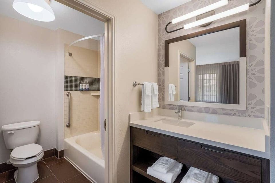 Refresh after adventures with a bright vanity and shower-tub combo.