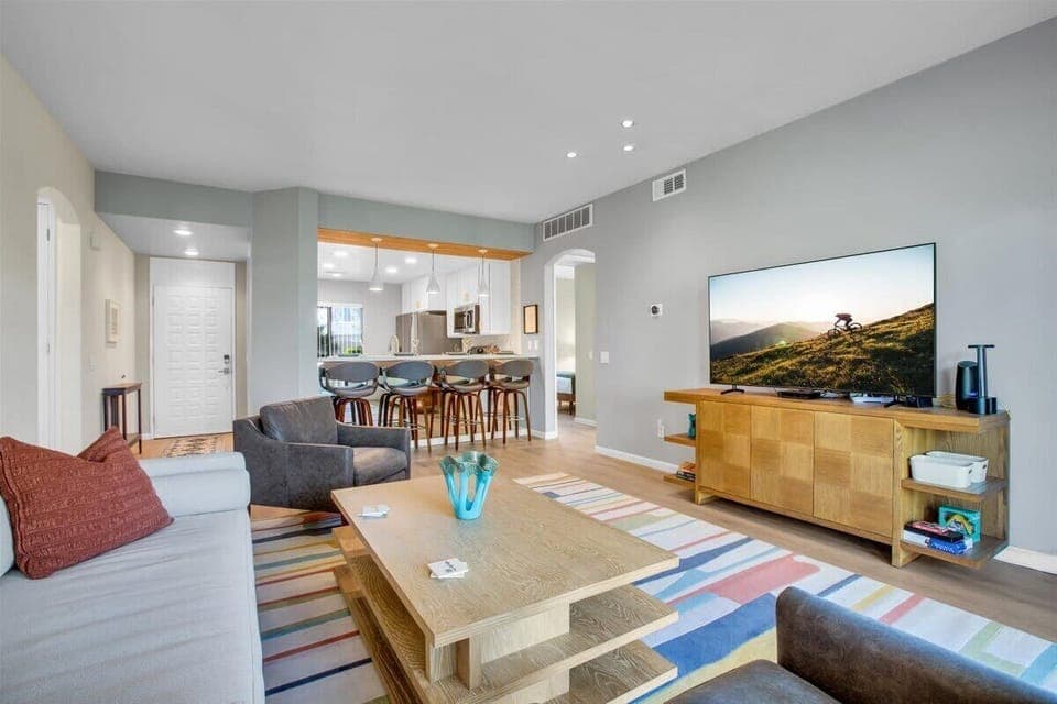 Step into our bright, open living room designed for relaxation & enjoyment. This contemporary space features ample seating, perfect for cozy gatherings or movie nights with friends or family. Sink into the plush sofa or stylish armchairs and unwind!