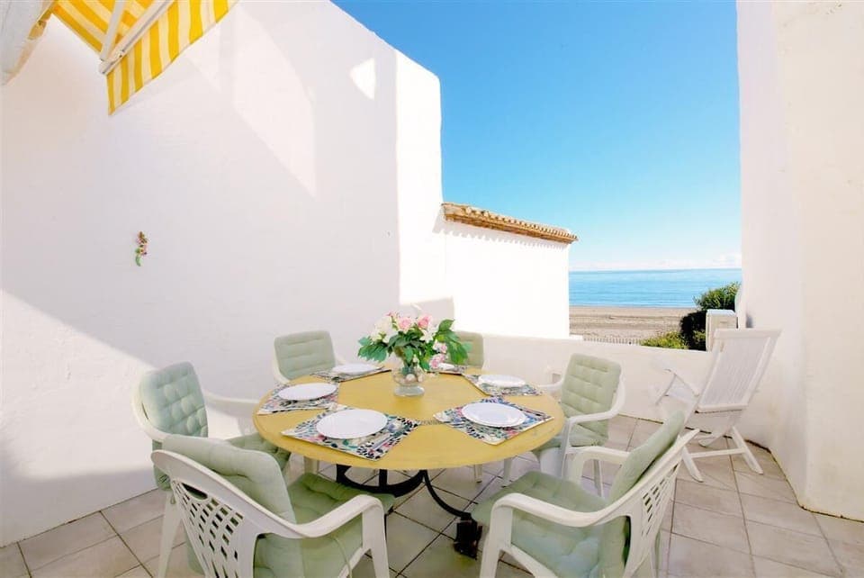 Private sunny terrace with outdoor dining area and sea views