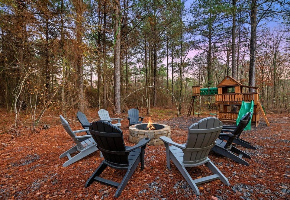 Gather around the inviting fire pit surrounded by towering pines—perfect for roasting marshmallows, storytelling, and unwinding under the stars.