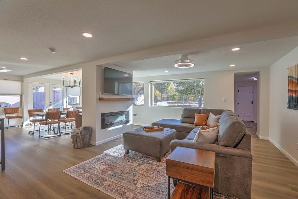 Cozy up fireside—roomy sectional, smart TV, and comfy vibes for the whole crew.