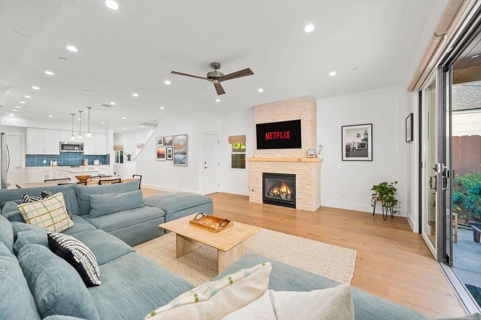 Enjoy the spacious and comfortable sectional family room sofa while watching a show on the smart TV. Cozy up by the fireplace on cooler days and open the large back sliding doors to let the breeze in on warmer days.