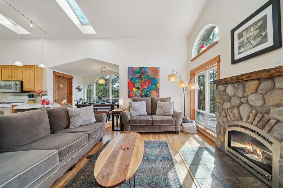 Open living space with, Living room with Gas fireplace, Roku TV, dining room, fully equipped kitchen and access to upper deck.