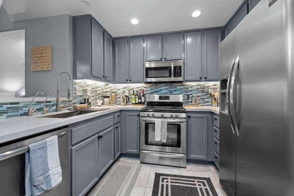 Modern full kitchen featuring sleek metal appliances, combining style and functionality for an exceptional cooking experience.