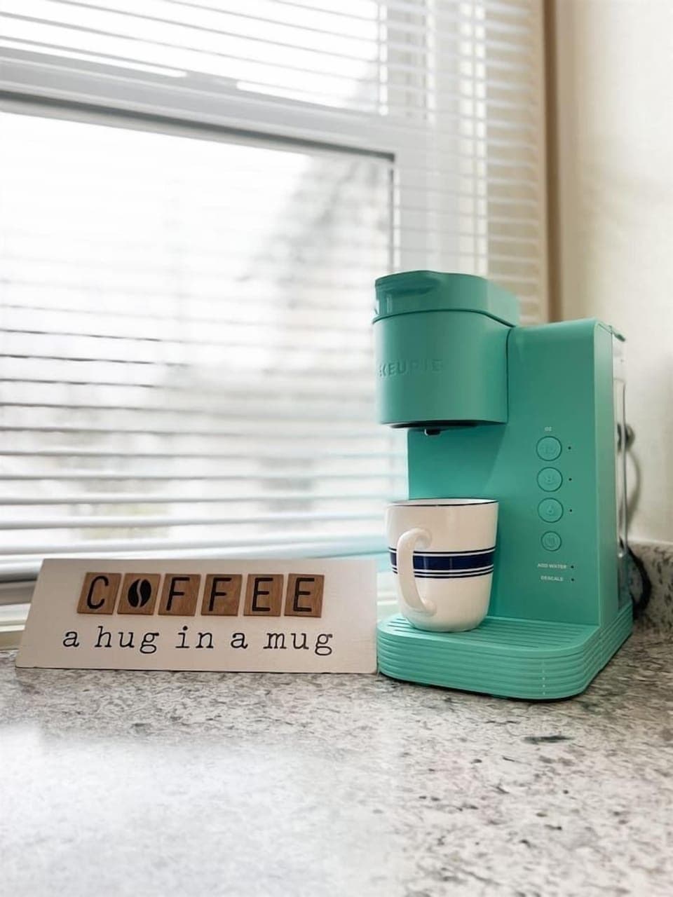 Full kitchen featuring a sleek coffee maker, perfect for coffee lovers, with a motivational touch to inspire the love of coffee. A cozy, functional space designed for brewing your favorite cup and adding warmth to your kitchen experience