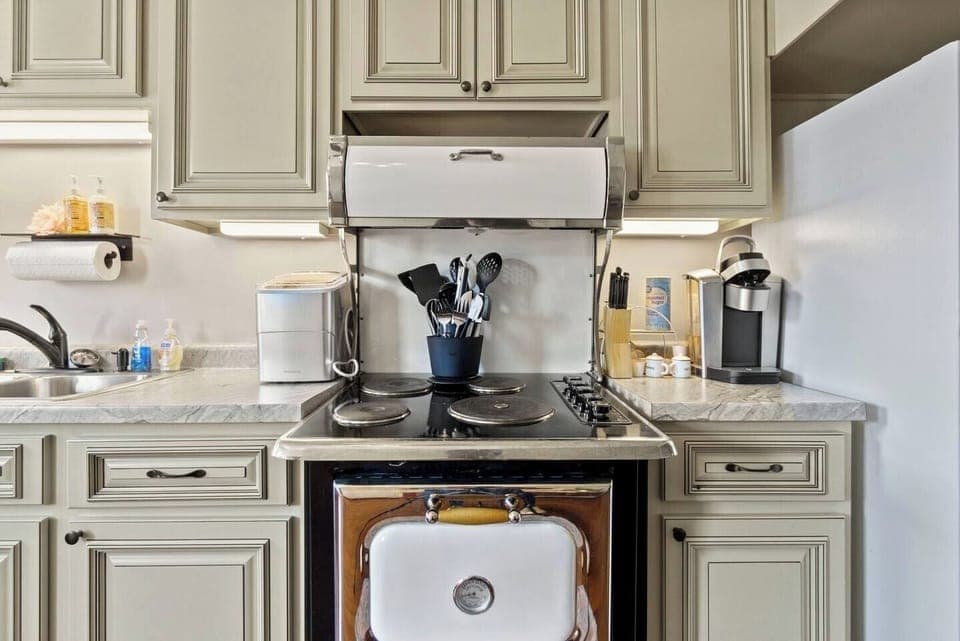 Full kitchen with modern appliances and ample cabinets, offering plenty of storage and space for all your cooking needs.