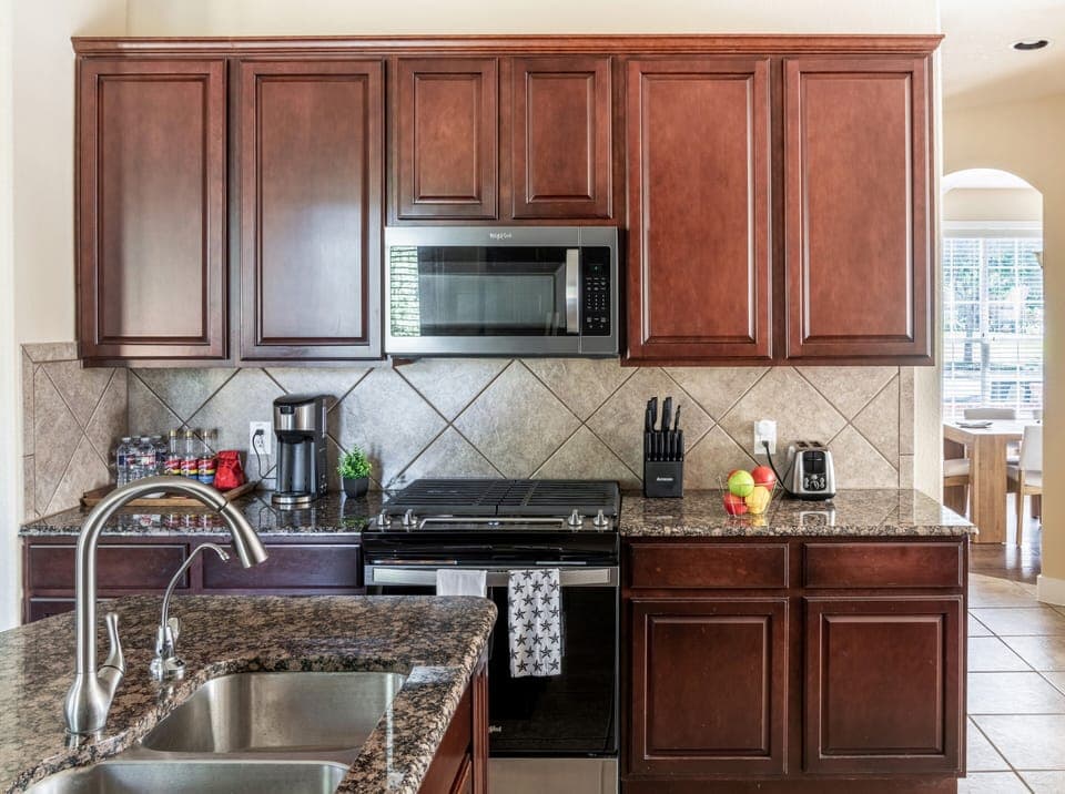 Full kitchen with granite countertops and stainless steel appliances