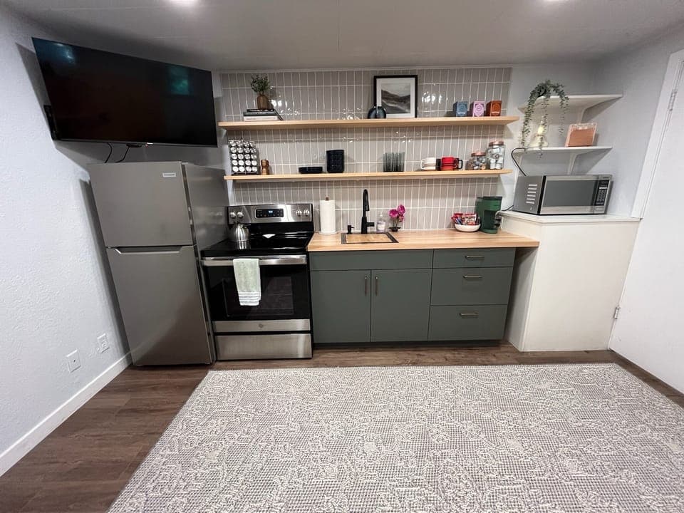 Full kitchen stocked with everything you need to cook and serve a meal.