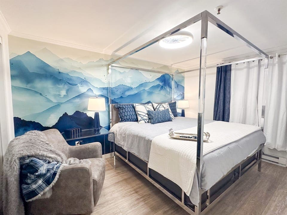 The first KING bedroom is themed for your mountain getaway, and features a Casper mattress, designer bed, writing desk, comfy swivel chair, and 55-inch smart TV.