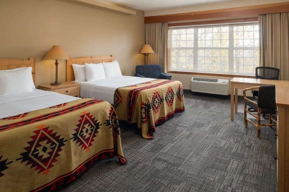 Unwind in a bright room with plush beds and calm views