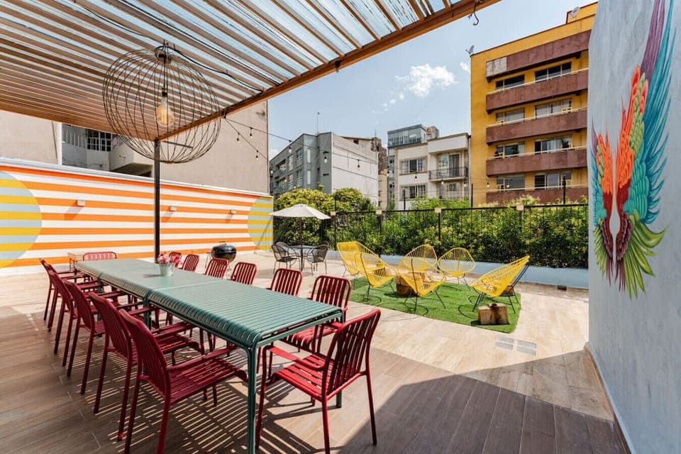 Covered outdoor space with seating, ideal for day or evening gatherings.