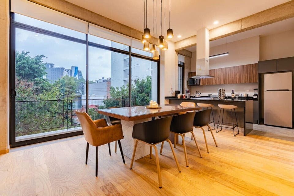 Enjoy dining in style with large windows showcasing the surrounding greenery.