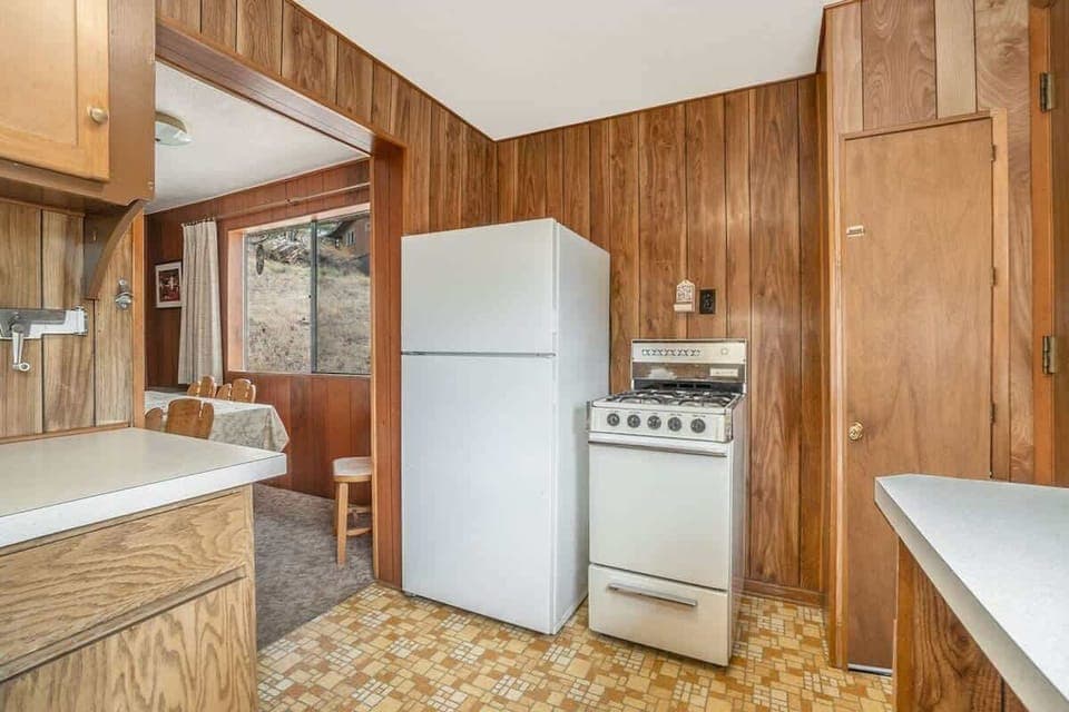 Kitchen with fridge freezer combo and gas stove.