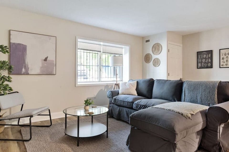 The living room’s cozy vibe makes it the perfect spot to relax, with ample seating and a warm ambiance.