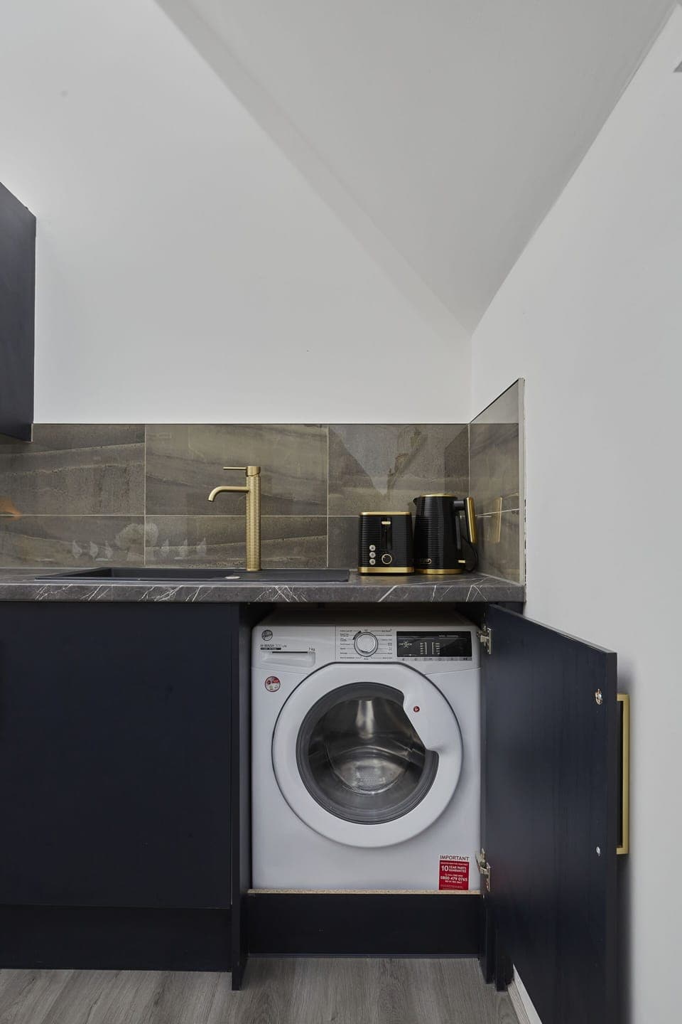 Convenient laundry area with washing facilities for longer stays.