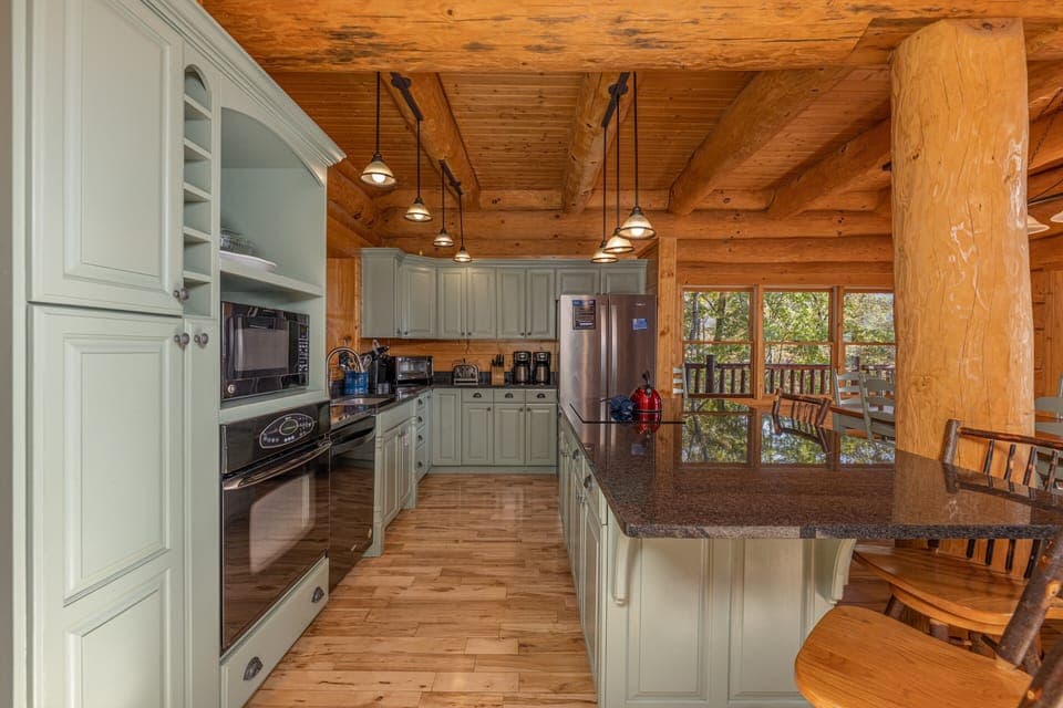 Full kitchen with island and green cabinets