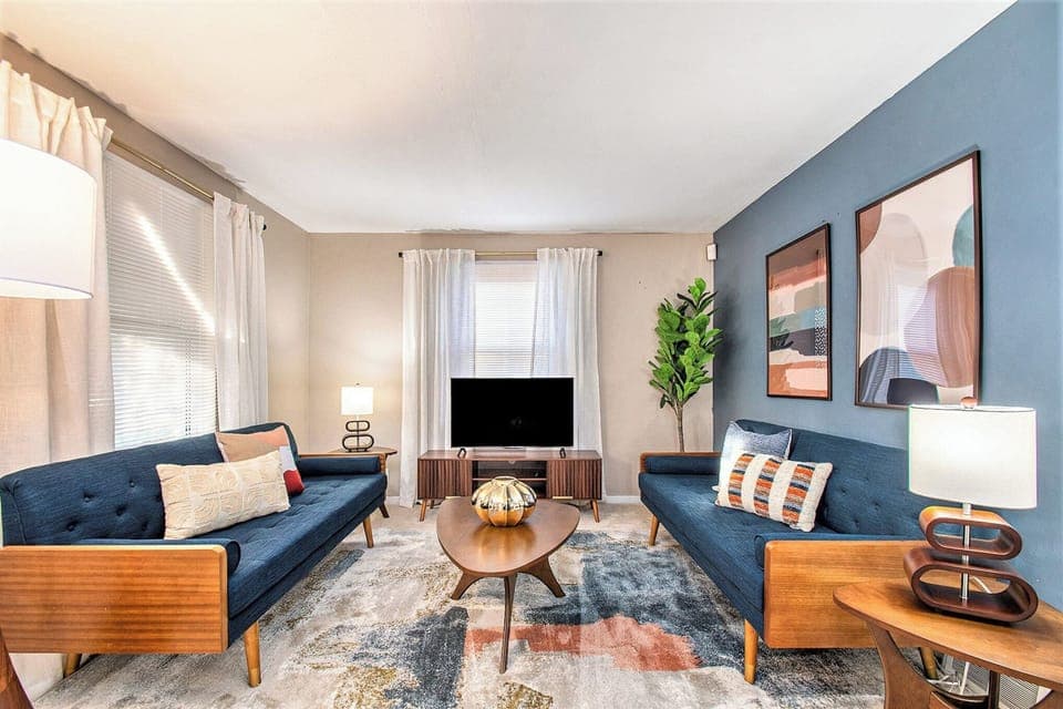 Cozy living room with 2 plush couches, TV, and elegant vibes