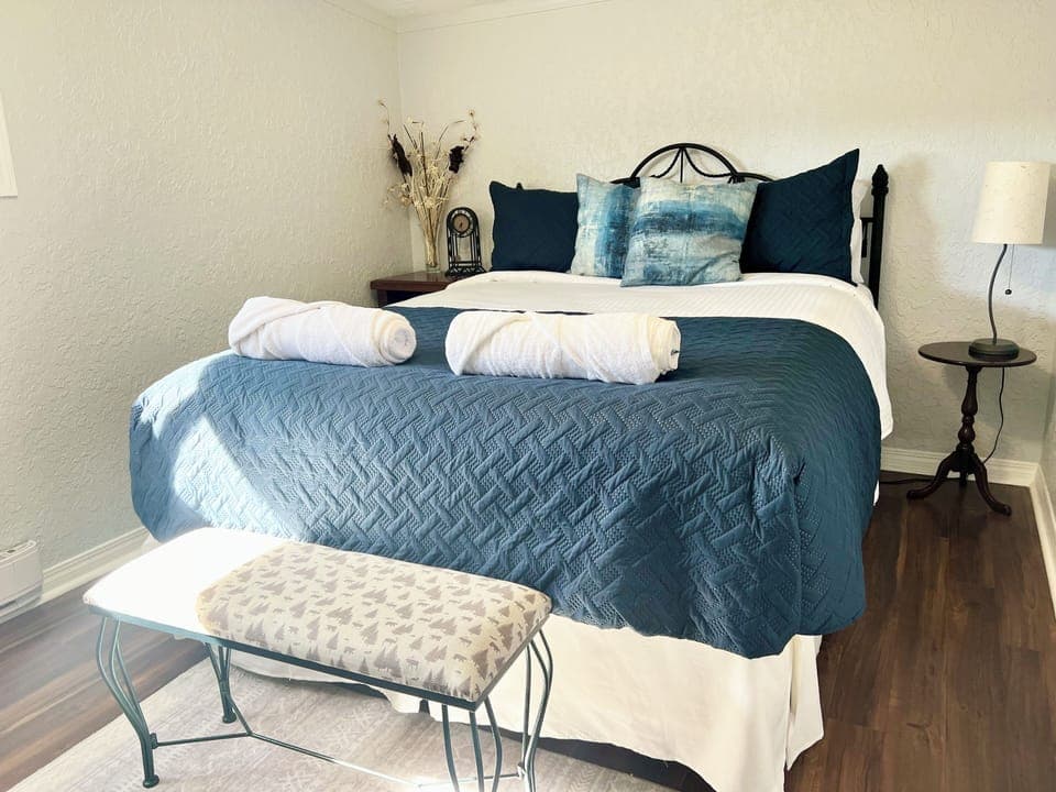 Primary bedroom with king-size bed and closet.