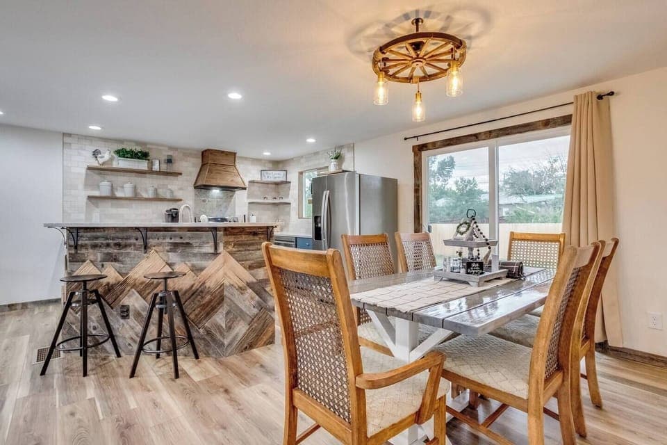 Dining room and kitchen with glass sliding door into the backyard. Seating for 8 people.
