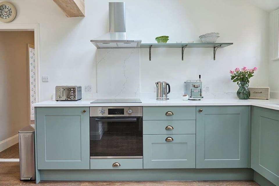 Fitted kitchen with dishwasher, microwave, oven, induction hob, washer dryer.