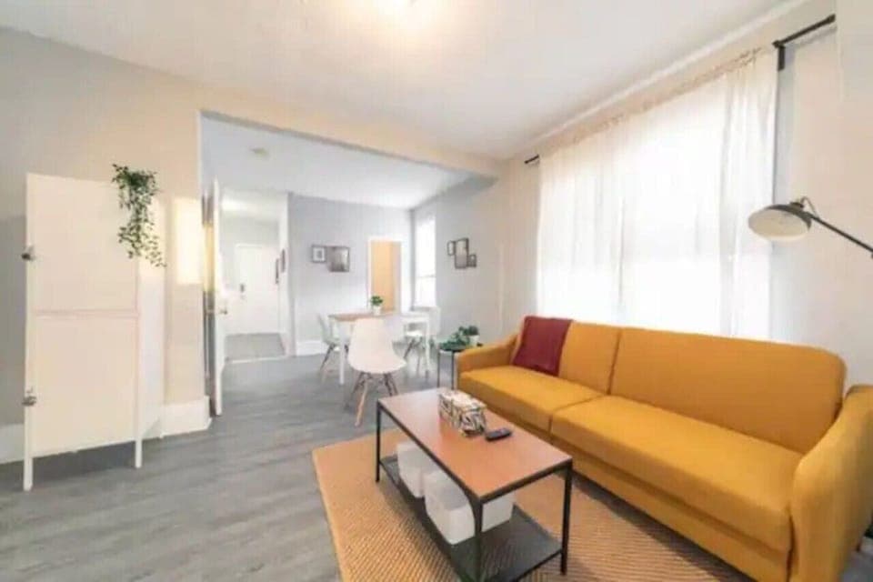 The living room is filled with natural light, creating a bright and welcoming space that invites relaxation.