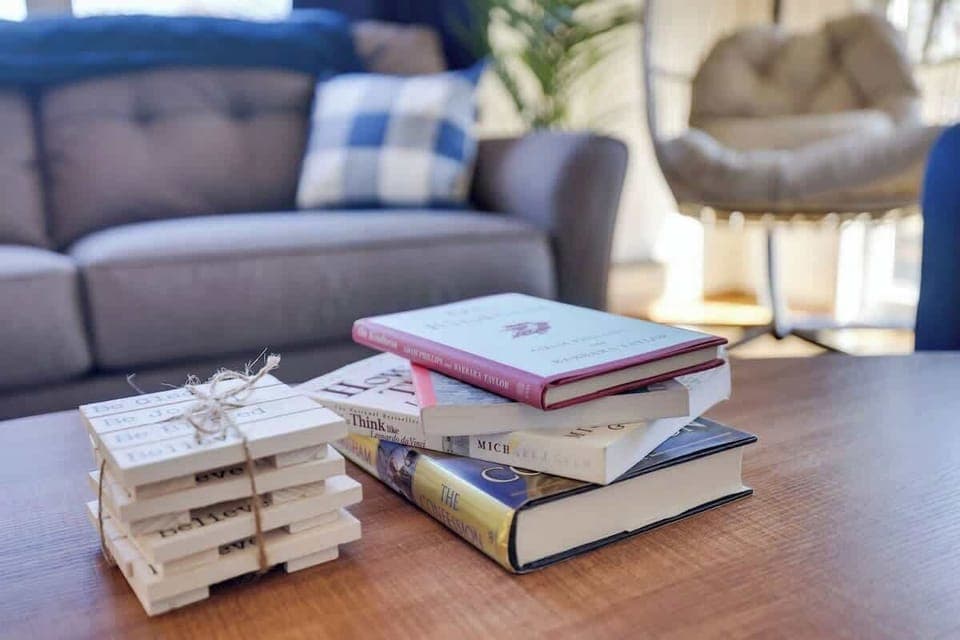 Settle into this cozy living room, grab a book from the stack, and enjoy a moment of quiet escape.