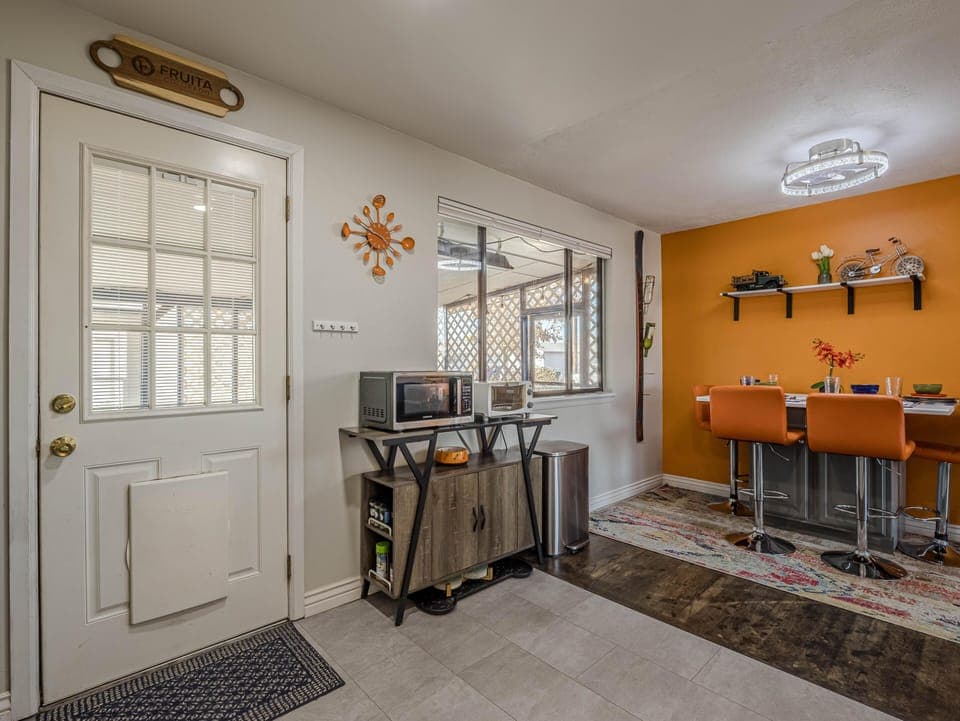 Mid-Century Modern accents and pops of vibrant color bring the dining area to life.