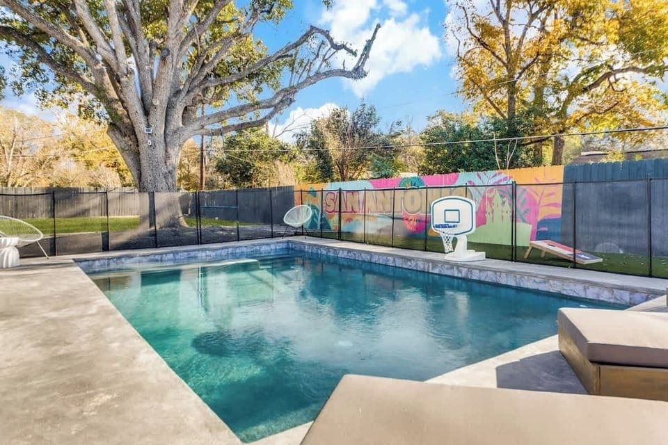 Heated outdoor pool with basketball hoop and plenty of lounge chairs!