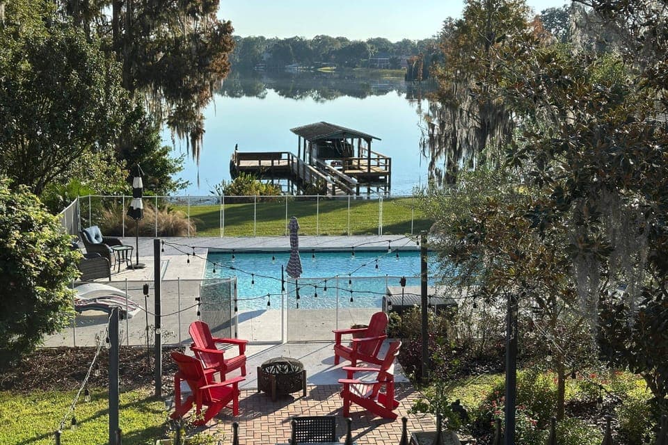 Welcome to Otis Sunrise Villa - Your View From the Primary Bedroom overlooking the backyard pool & lake!