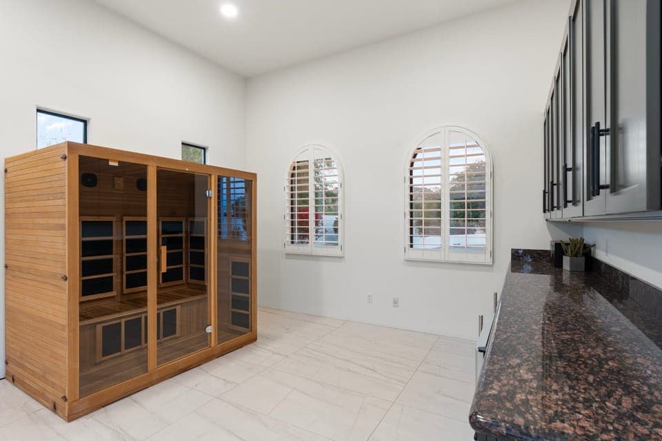 2 person infrared sauna and bar area with beverage fridge