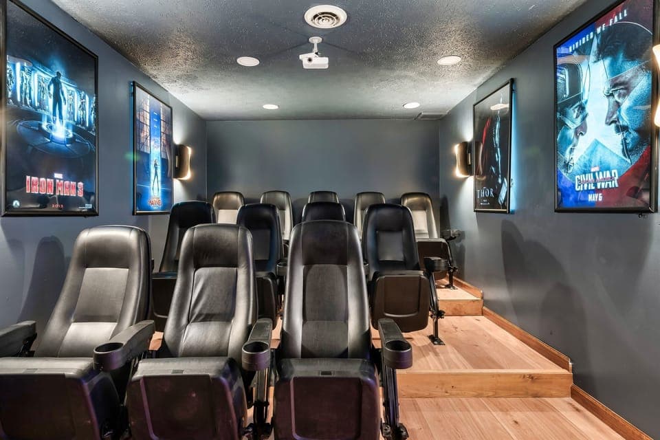 Gorgeous movie room with backlit posters.