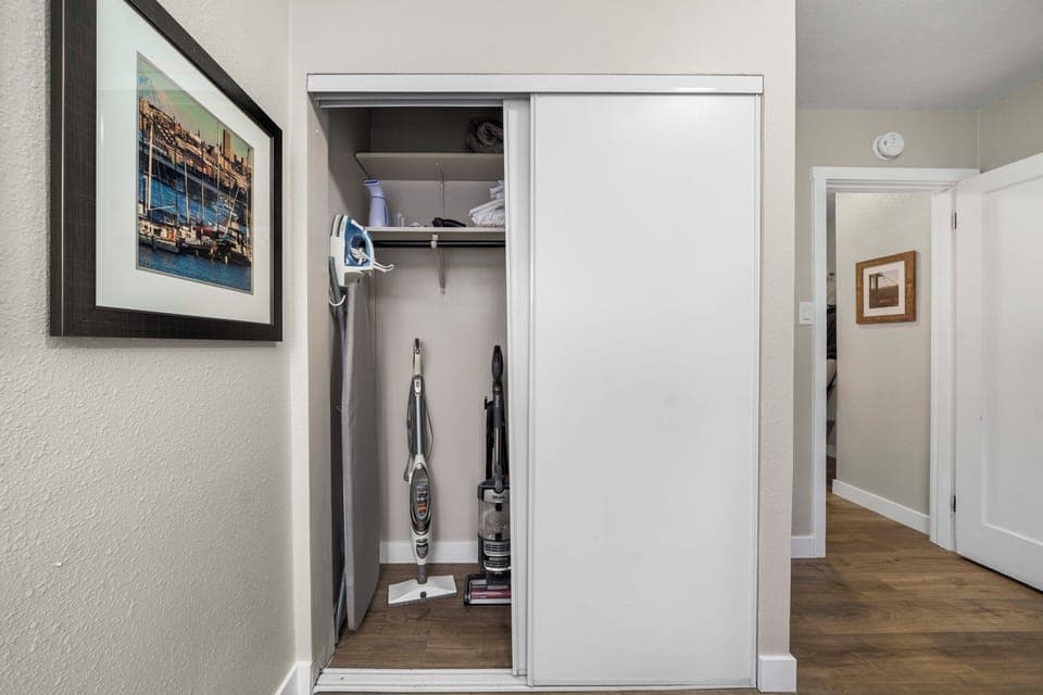 An iron, ironing board, clothes steamer, vacuum and extra linens provided.