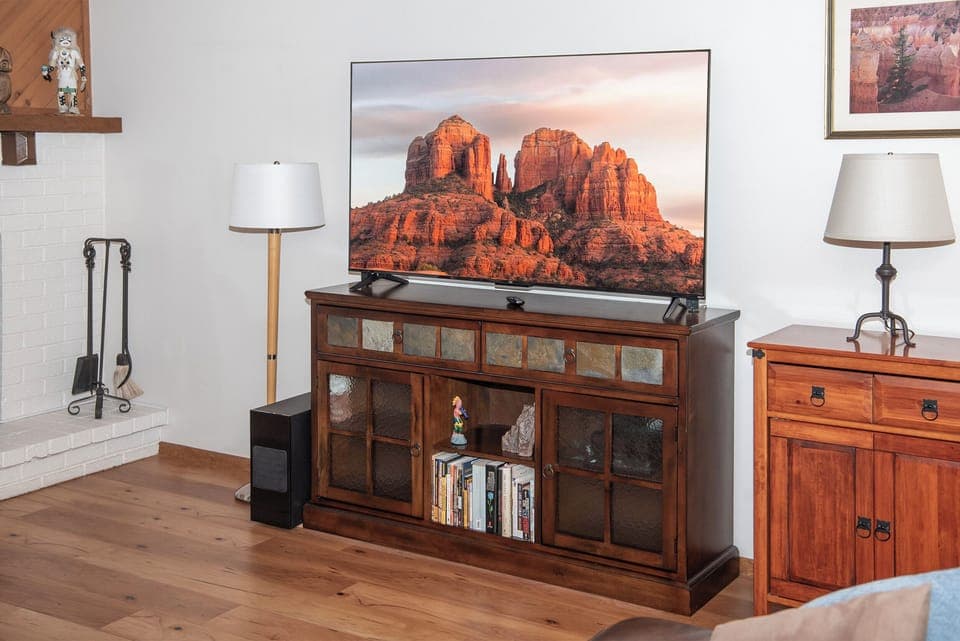 The living room features a 65" smart TV