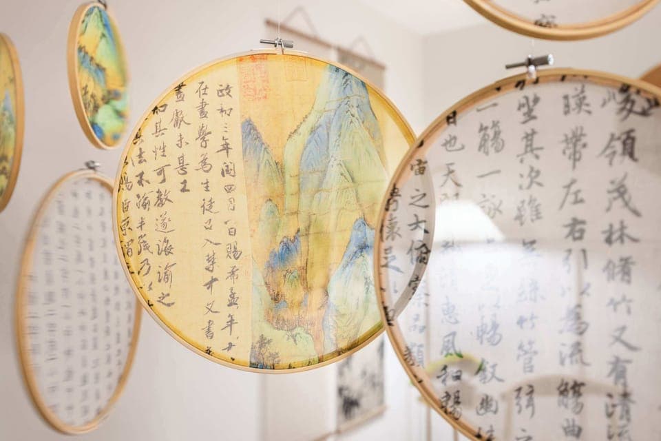 This unique decorative feature showcases intricately designed hanging hoops with beautiful artwork and calligraphy. The delicate details add an artistic and cultural touch, making the space feel both elegant and inspiring.