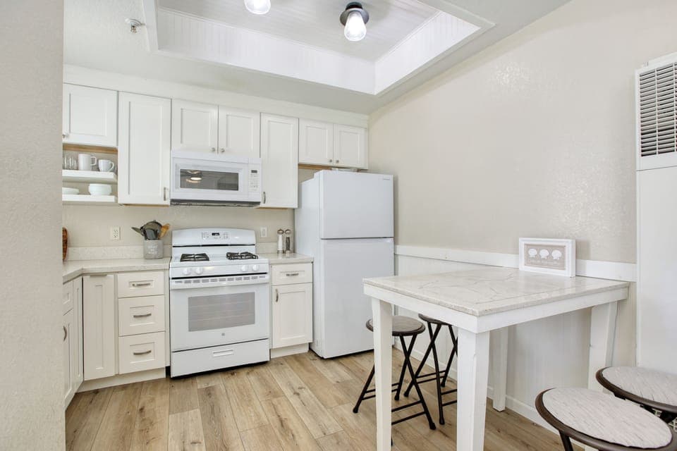 The fully equipped kitchen awaits your culinary creations, perfect for preparing delicious meals after a sun-soaked day at the beach.