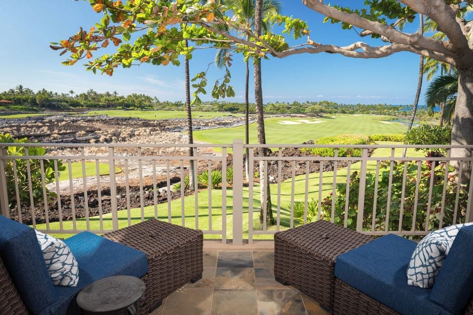 Outdoor seating for two on the Primary Bedroom lanai overlooking lush landscapes and serene golf course vistas.