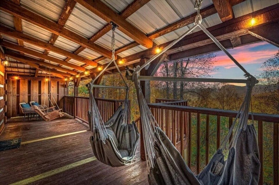 Unwind on our cozy, covered deck with swinging hammock chairs and sunset views. 