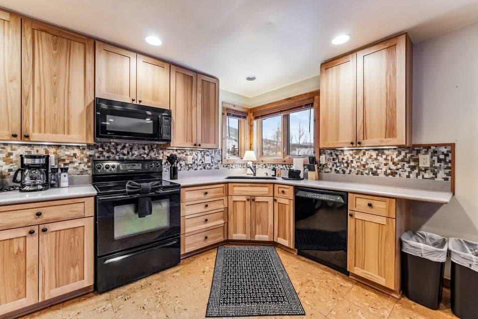 Kitchen: Drip coffee maker, Crockpot, toaster, cooking utensils, tableware