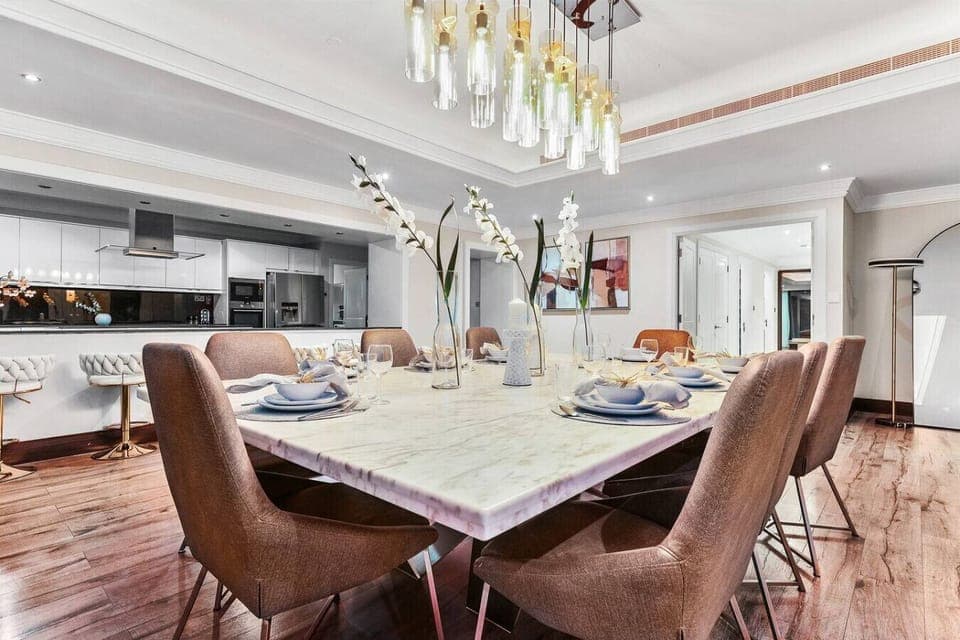 Modern luxury living and dining spaces with stunning city and waterfront views.