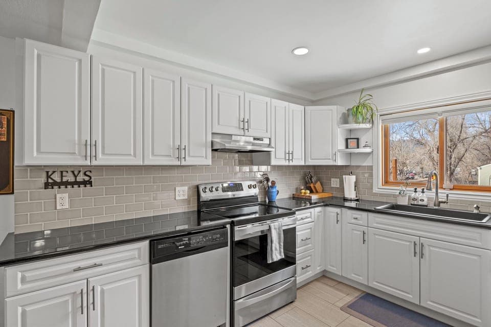 Kitchen with dishwasher, oven, and stove